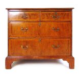 An early 18th century and later walnut and banded chest of two short over two long drawers on