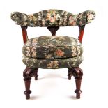 A Victorian walnut swivel chair upholstered in a floral pattern fabric,