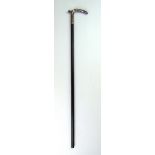 A continental white metal and ebonised walking cane having a zoomorphic handle, l.