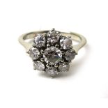 An 18ct white gold cluster ring set with nine brilliant cut diamonds in a flowerhead setting