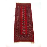 A handwoven Afghan rug, The multi line border surrounding a red ground field with twelve octagons,