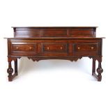 A reproduction 18th century style oak sideboard,