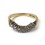 A 9ct gold and diamond ring, the seven stones totalling approximately 0.2ct. Approx weight 2.3g.