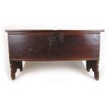 A late 17th century oak six plank coffer, the top lifting to reveal a vacant interior, h. 62 cm, w.