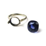 A white metal dress ring set with a blue coloured stone. Approx weight 4.2g. Size M.
