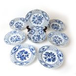 A collection of seven blue and white Meissen Onion pattern plates and one bowl having reticulated