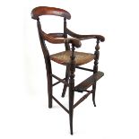 A 19th century beech child's high chair with caned seat on turned legs, h.86 cm, w. 42 cm, d.