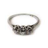 A white metal and diamond trilogy ring marked 'Plat', the three stones totaling approximately 0.4ct.