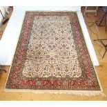 A handwoven Persian rug, the herati border surrounding a cream ground field with floral motifs,