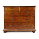 An early 18th century figured walnut and herringbone banded chest of two short over three long