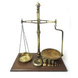 A set of 19th century W&T Avery brass pan balance scales on a walnut base, h.