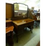 An early 20th century mahogany dressing table supported on cabriole supports