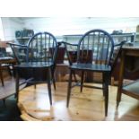 A pair of dark Ercol open arm chairs