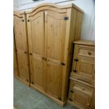 A pine two door arch topped wardrobe