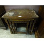 A nest of three reproduction oak occasional tables