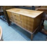 A Gordon Russell sideboard having three drawers flanked by cupboard doors