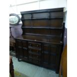 A dark Ercol dresser having a raised back section,