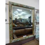 A floral framed wall mirror