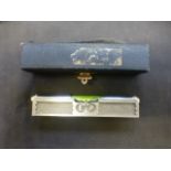 A Woods miniature metal spirit level in fitted case