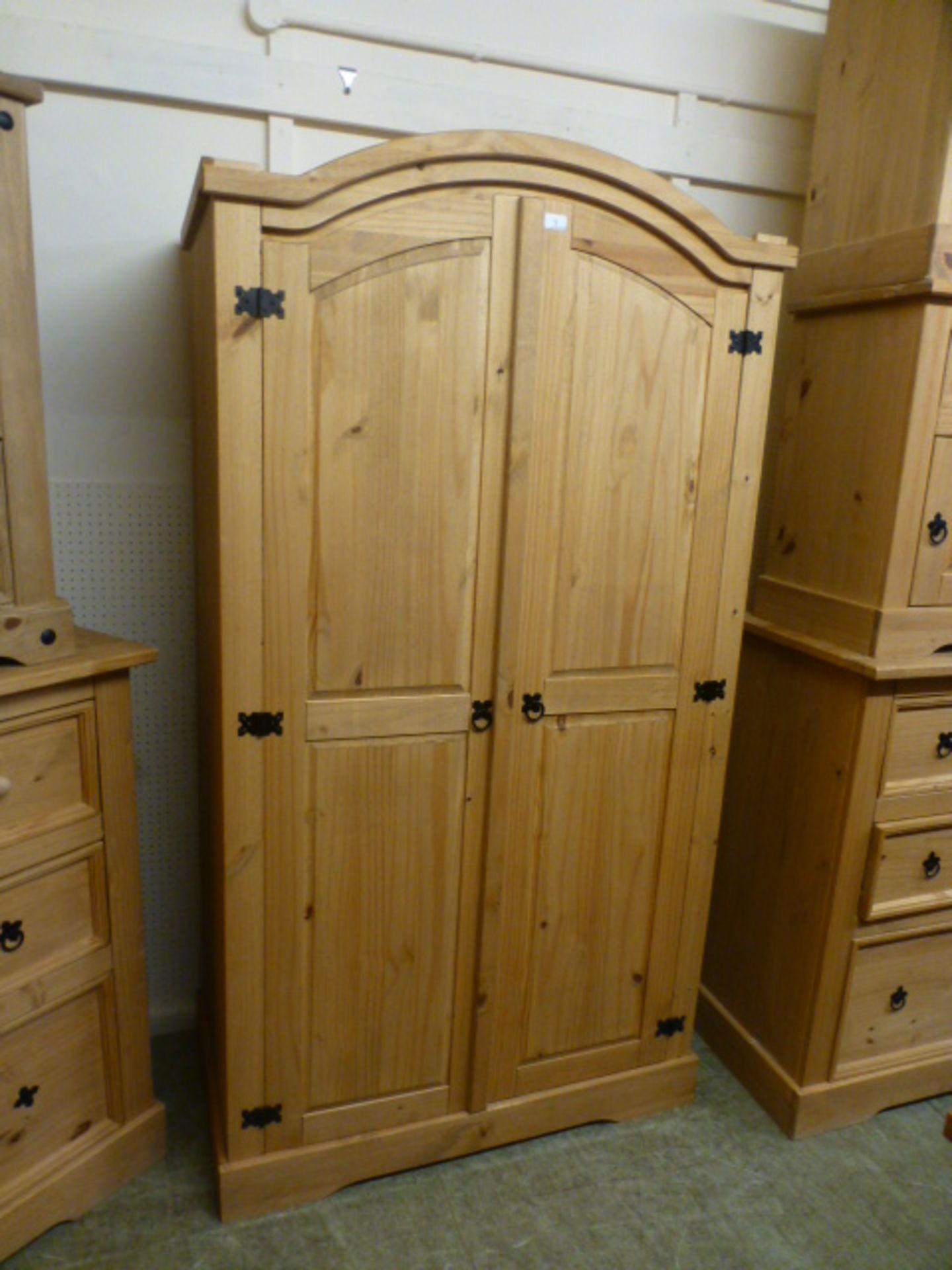 A modern pine two door arch topped wardrobe