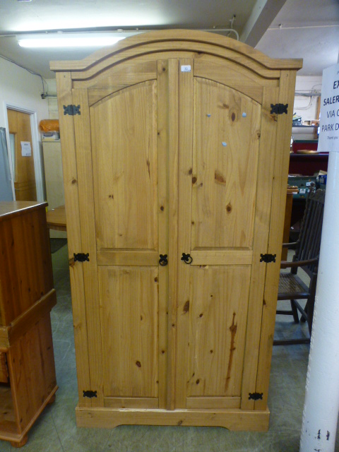 A pine two door arch topped wardrobe