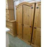 A pine two door arch topped wardrobe
