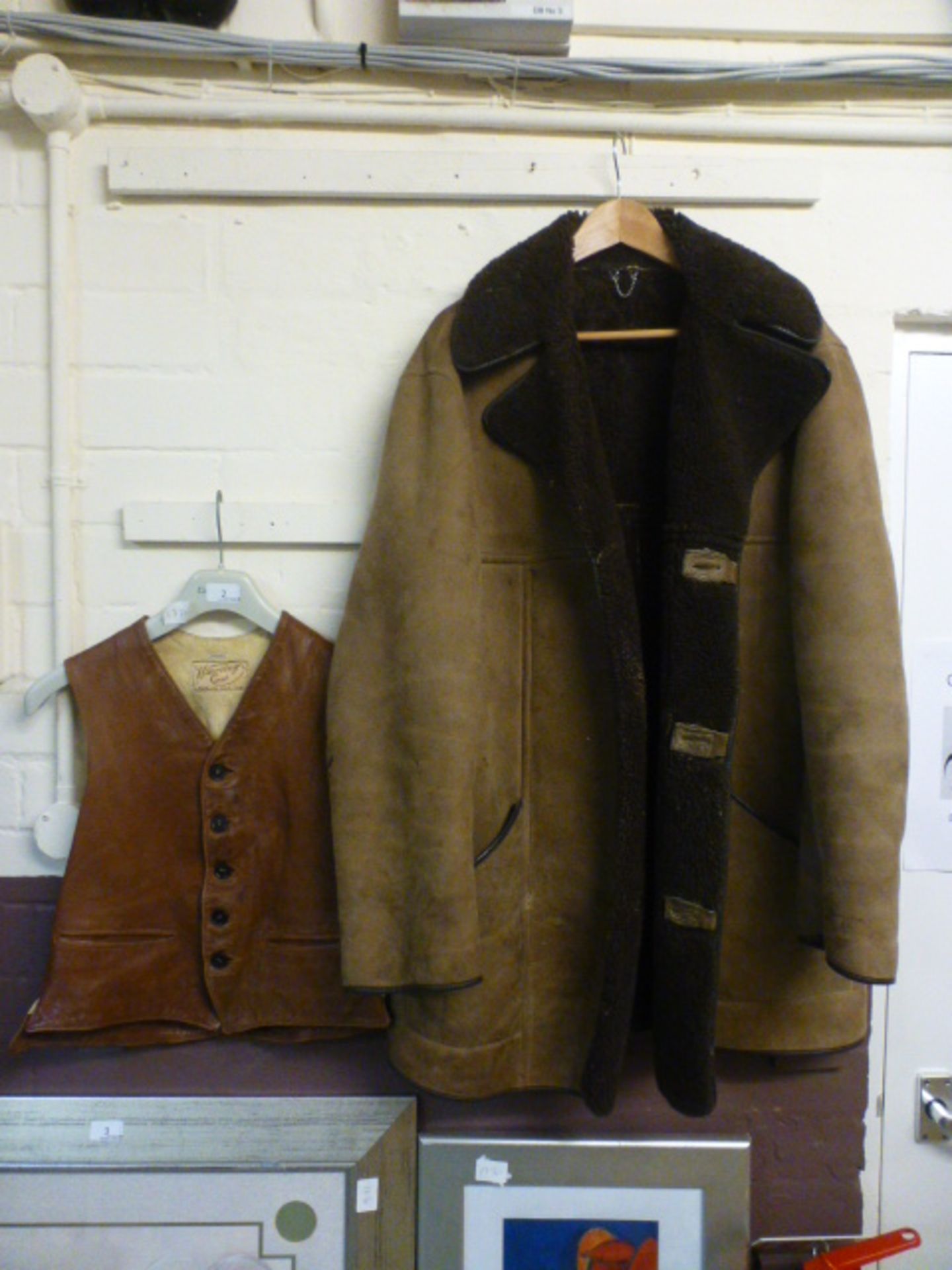 A Wareing leather waist coat along with a sheepskin jacket