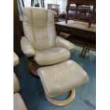 A cream leather reclining swivel chair with matching stool