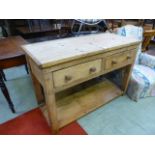 A waxed pine dresser base having two drawers above open storage