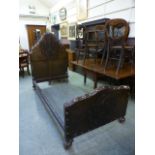 An Spanish style bedstead having an embossed brown leather head and foot