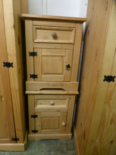 A pair of stripped pine bedside cabinets