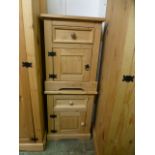 A pair of stripped pine bedside cabinets