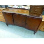 A mid 20th century mahogany serpentine fronted sideboard having three drawers being flanked by