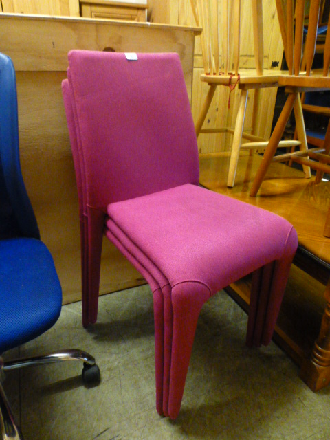 A set of three cerise upholstered chairs