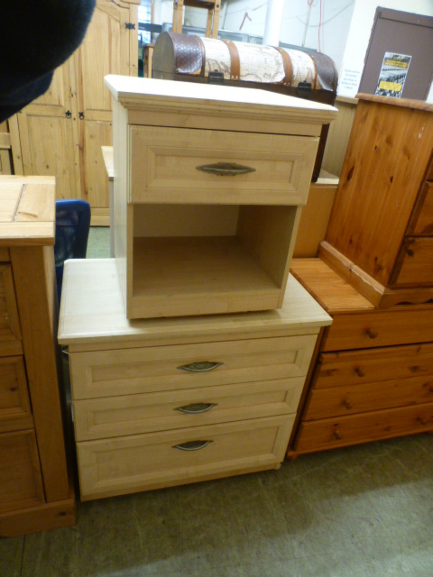 A sycamore effect chest of three long drawers along with a matching bedside cabinet
