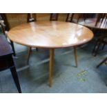 A light Ercol drop leaf table CONDITION REPORT: Top in need of refinishing