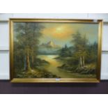 A modern gilt framed oil on canvas of a lake land mountain scene signed bottom left