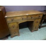 A mid 20th century oak desk having two drawers above pedestal section