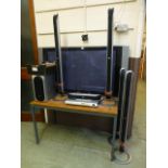 An LG flat screen TV along with a LG DVD player, surround sound speakers etc.
