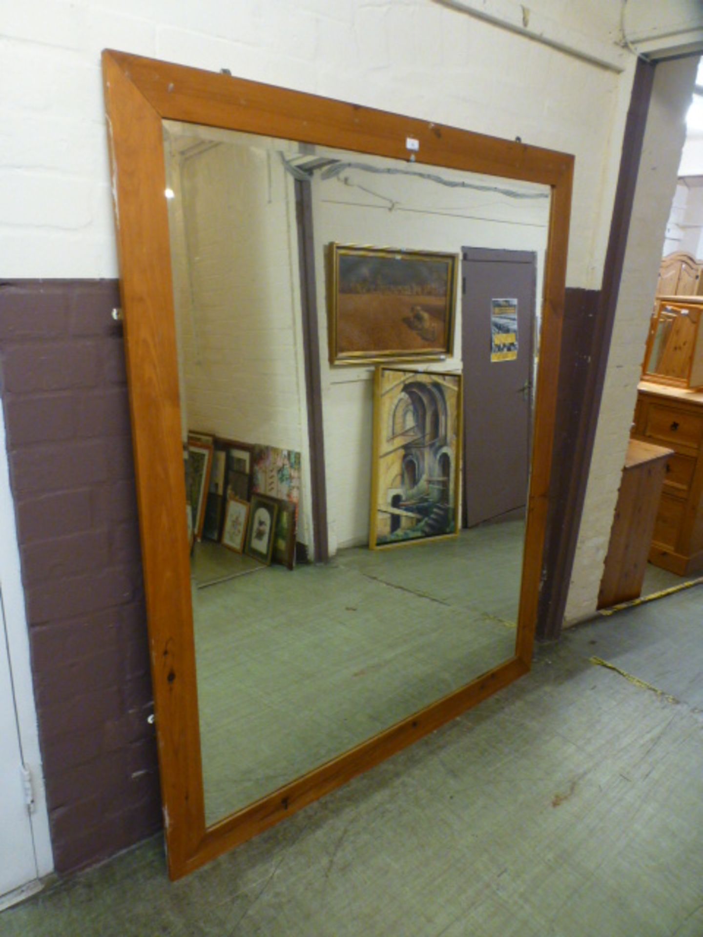 A substantial pine framed beveled glass mirror,