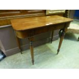 An early 19th century mahogany side table on turned legs,