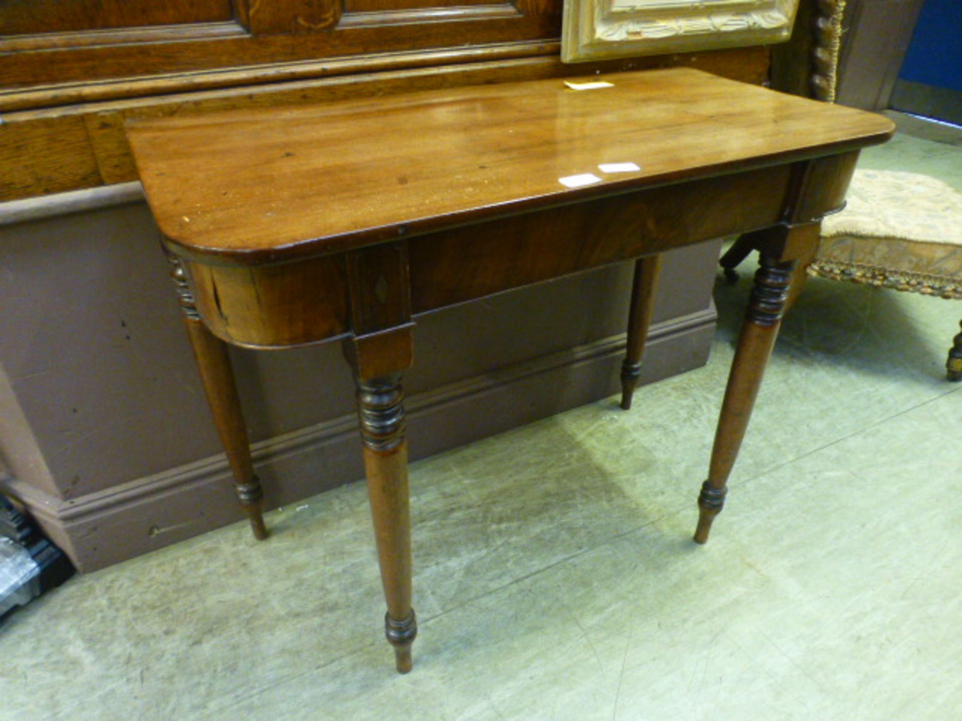 An early 19th century mahogany side table on turned legs,