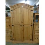 A pine two door arch topped wardrobe