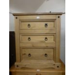 A stripped pine chest of three drawers