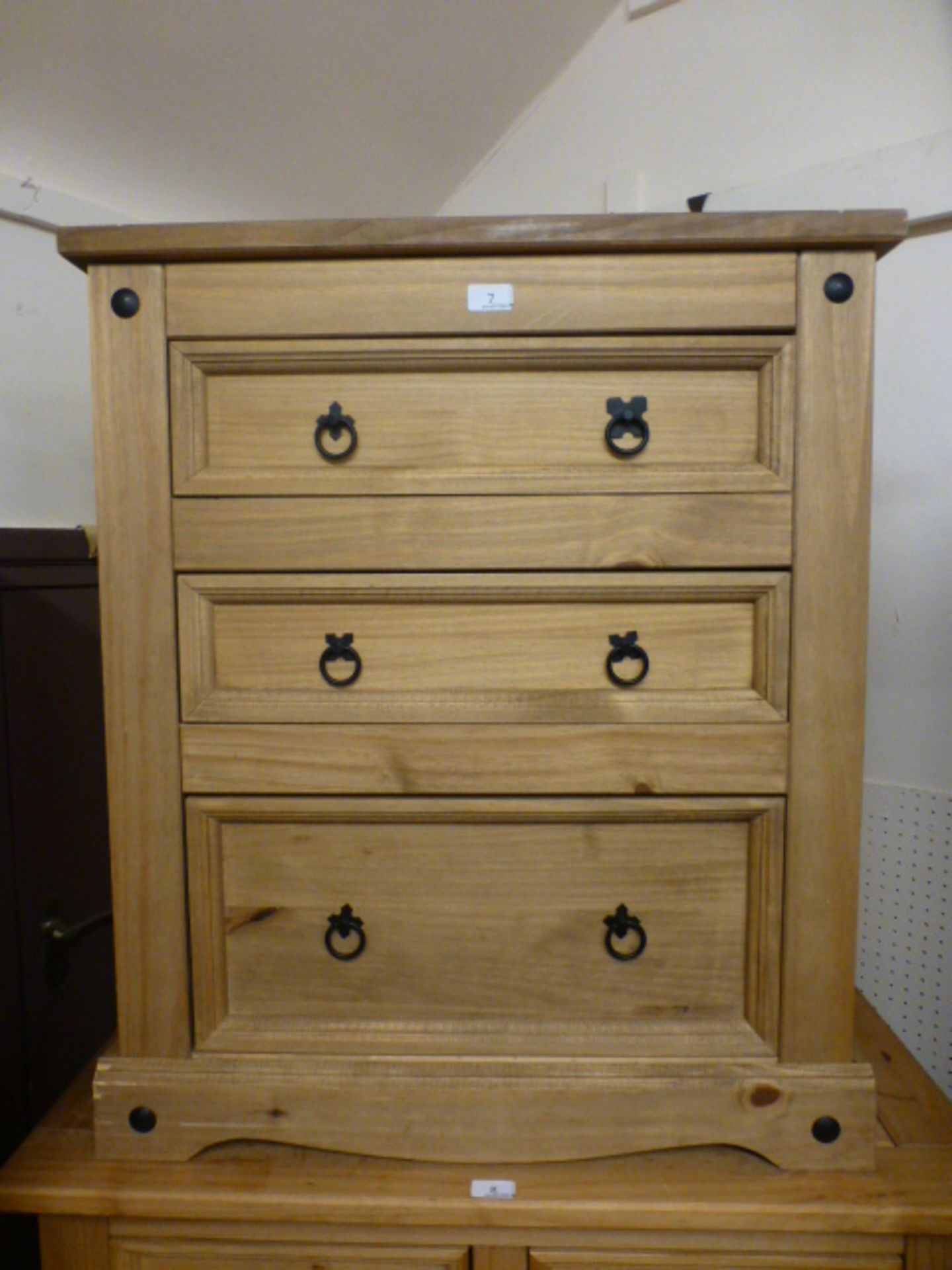 A stripped pine chest of three drawers