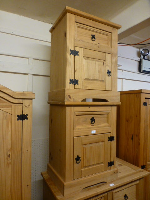 A pair of stripped pine bedside cabinets,