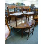 A mid 20th century design teak extending dinning table together with a set of four matching chairs