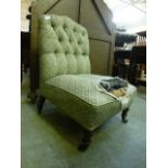 A Victorian nursing chair upholstered in a distressed green striped fabric