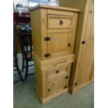A pair of pine bedside cabinets having drawer over cupboard door