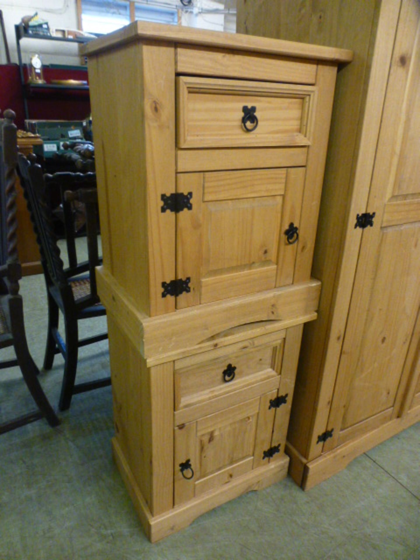 A pair of pine bedside cabinets having drawer over cupboard door